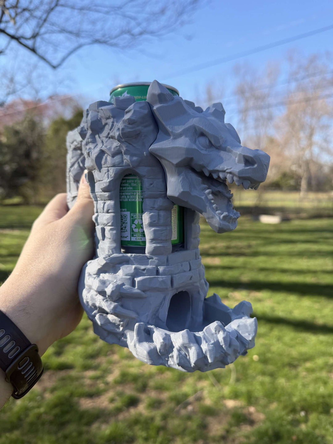 Unpainted grey Dragon’s Fortress Can Holder and Dice Tower with dragon motif and stonework design for tabletop gaming