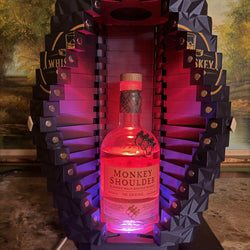 Precision 3D-printed LED whiskey display case showcasing spirits on display with warm integrated lighting for home bars