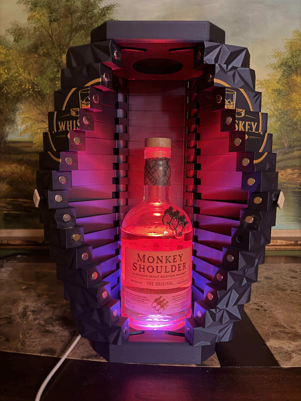 Precision 3D-printed LED whiskey display case showcasing spirits on display with warm integrated lighting for home bars