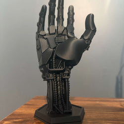 3D-printed robot hand controller stand with detailed mechanical joints and sleek metallic finish for gaming setups