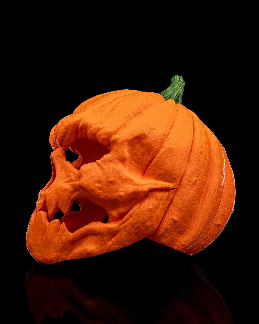 Pumpkin Head Mask in textured orange with a green stem, sculpted ridges and hollow eye and mouth openings