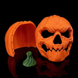 Pumpkin Head Mask in textured orange pumpkin material with jagged skull-like eye and mouth openings, shown with green stem