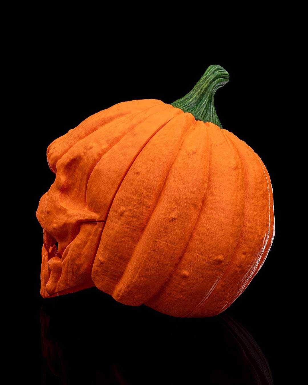Pumpkin Head Mask in textured orange with deep ribbed grooves, a green stem, and a sculpted snarling face